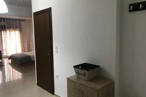 a bedroom with a bed and a box on a table at Beauty Home Orestiada Center in Orestiada