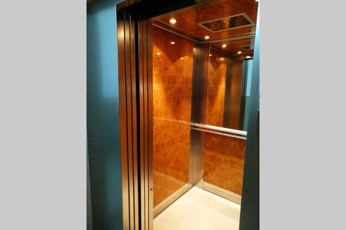 a glass shower in a room with a blue wall at Beauty Home Orestiada Center in Orestiada
