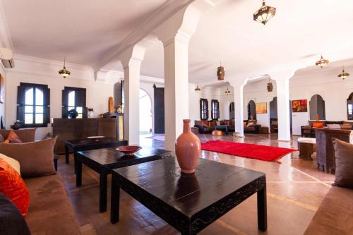 a living room with couches and a table at Kasbah Caracalla in Aghmat