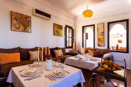 a living room with two tables and a couch at Kasbah Caracalla in Aghmat