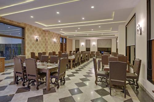 a restaurant with tables and chairs in a room at Clarks Safari Ranthambore in Khilchipur