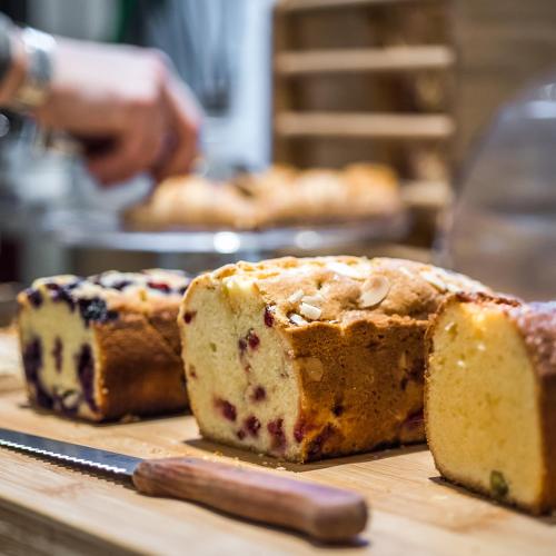 a loaf of bread on a cutting board with a knife at Maison Volver in Arles