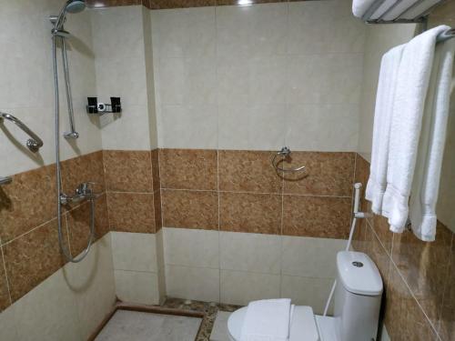 a bathroom with a shower and a toilet and a shower at Sultan Hotel in Mecca
