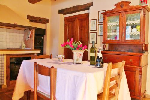 a table with a white table cloth and flowers on it at Casa Vacanze La Meridiana in Serrungarina
