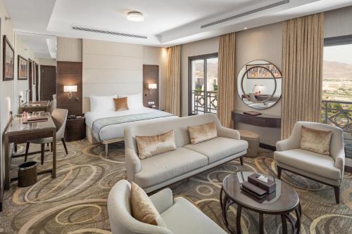 a hotel room with a bed and a living room at Millennium Makkah Al Naseem in Makkah