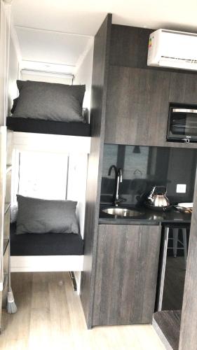a small room with a bunk bed and a sink at Chelenko Lodge in Puerto Tranquilo