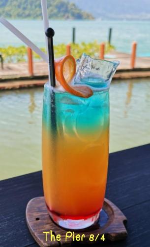 a drink on a table with an orange slice in it at Parama Koh Chang in Ko Chang