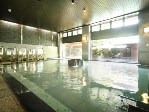 an empty swimming pool in a large building at Rurikoh in Kaga