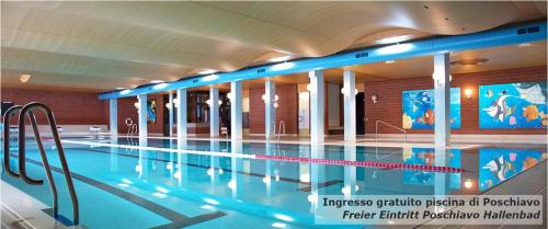 a large swimming pool in a building at Historic Hotel Albrici in Poschiavo