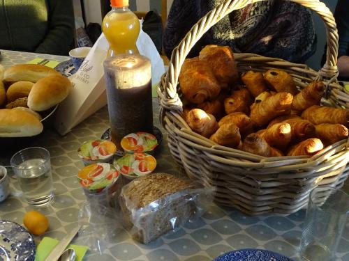 a basket of bread and a basket of pastries on a table at Villa Vigor in Peer