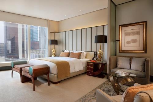 a hotel room with a large bed and a couch at MGM Macau in Macau