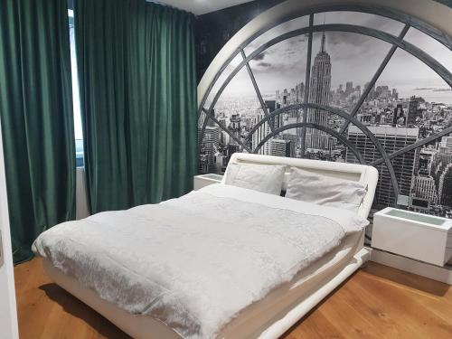 a bedroom with a white bed with a large window at Old Town - EuroEastVentures Luxury Properties in Bucharest