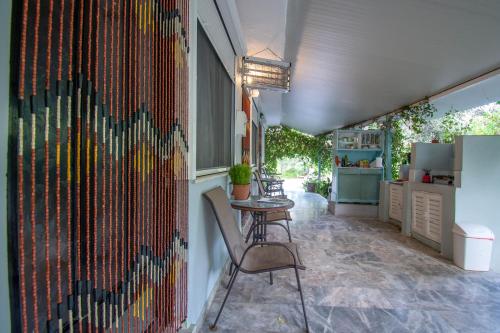 a kitchen with a table and chairs and a wall at Asmanis Rooms in Tarti