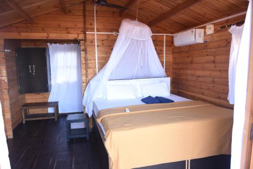 a bedroom with a bed in a wooden cabin at Agonda Paradise in Agonda