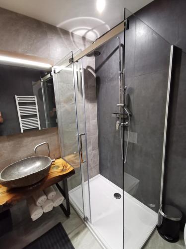 a bathroom with a glass shower and a sink at Hotel CityMap Maribor in Maribor