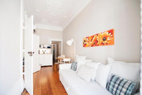 a white living room with a white couch at Apartamentos com História in Guimarães