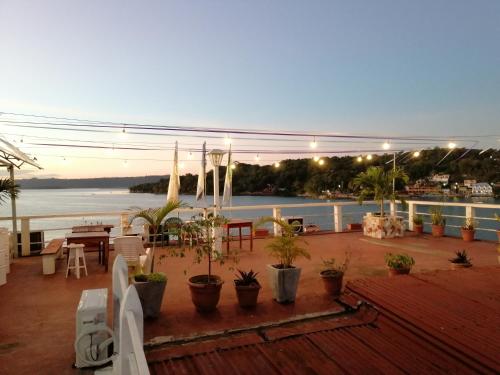 a view of a deck with a view of the water at Hotel La Union in Flores
