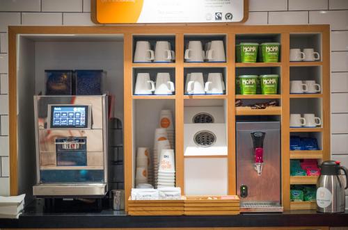 a kitchen with a counter with a refrigerator at Holiday Inn Express - Stockport by IHG in Stockport