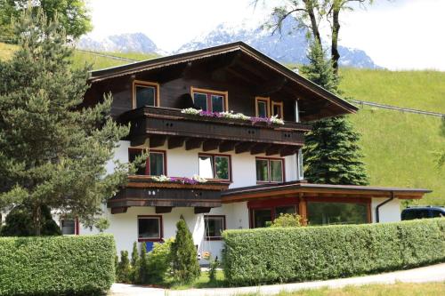 a house with a balcony on top of it at Zagglhaus in Scheffau am Wilden Kaiser