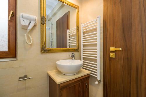 a bathroom with a white sink and a mirror at BUCUR 9 in Bucharest