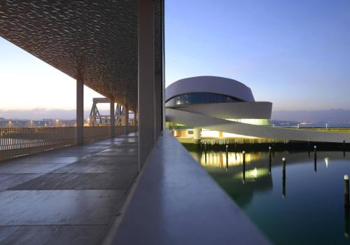 a building with a pool of water in front of it at Harbour Inn Design Townhouse in Matosinhos
