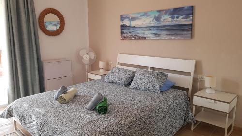 a bedroom with a bed with pillows on it at Marina Palace Paraiso in Playa Paraiso