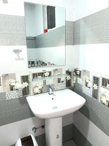 a bathroom with a white sink and a mirror at Sura Homestay Kandy in Kandy