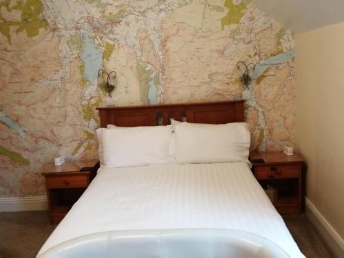 a bed in a room with a map on the wall at Dunsford Guest House in Keswick