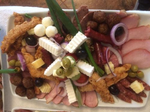 a plate of food with different types of food at PENSIUNE RESTAURANT POIANA AVRIGULUI loc de joaca pentru copii in Avrig