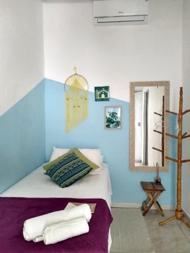 a bedroom with a bed with towels on it at Estação Caraíva in Caraíva