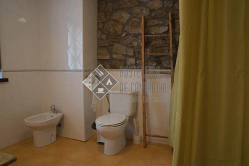 a bathroom with a toilet and a sink at Hostal casa lucas in Los Tojos