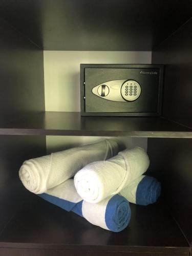 a shelf with two white and blue socks and a microwave at Beach Haus-Punta Estrella in Playa del Carmen