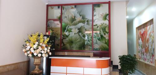 a lobby with a flower mural on the wall at Motel Xuân Hòa in Bắc Ninh