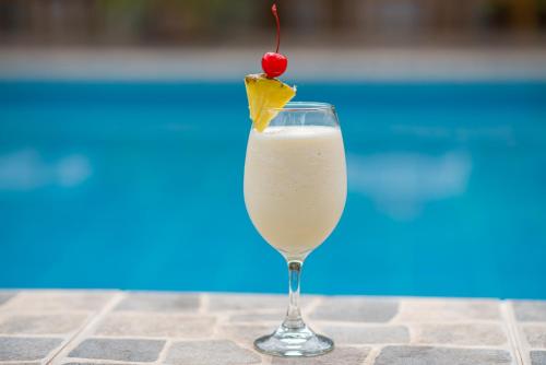 a glass of white drink with a cherry on top at Colina de Montalva in Tarapoto