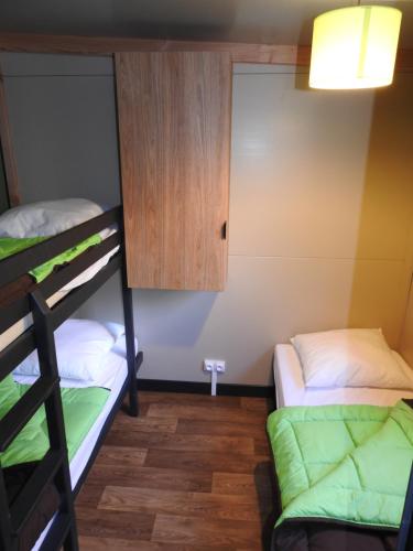 a room with two bunk beds and a cabinet at Camping Les Lavandes in Darbres