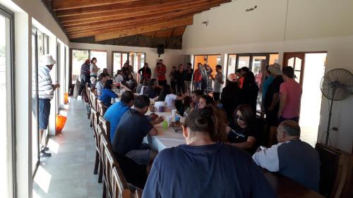 a group of people sitting at tables in a room at Willy's Country Club Cauquenes in De Cauquenes