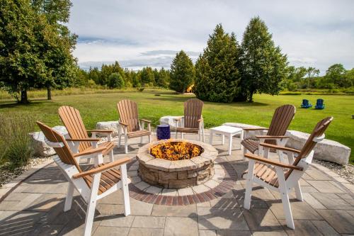 a patio with chairs and a fire pit at Open Hearth Lodge in Sister Bay