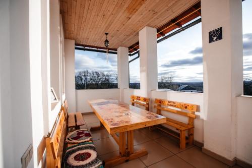 a porch with a wooden table and two benches at Samovar Hostel in Vladimir