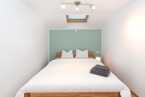 a bedroom with a large bed with white sheets at Panorama-Juwel Alpbachtal in Reith im Alpbachtal