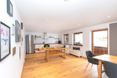 a dining room and living room with a table and chairs at Panorama-Juwel Alpbachtal in Reith im Alpbachtal