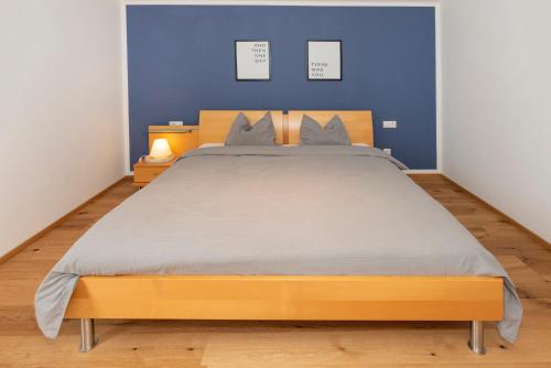 a bedroom with a large bed with blue walls at Panorama-Juwel Alpbachtal in Reith im Alpbachtal