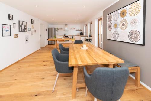 a dining room with a wooden table and chairs at Panorama-Juwel Alpbachtal in Reith im Alpbachtal