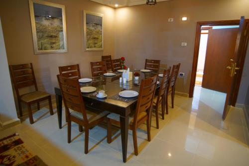 a dining room with a table and chairs at Over Mountains Hotel in Wadi Musa