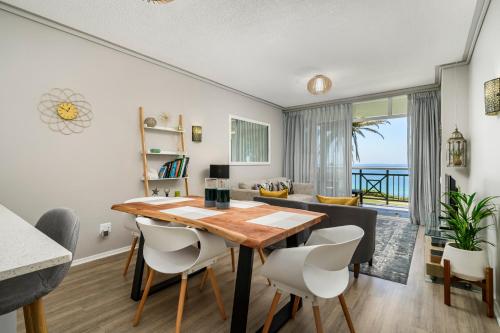a dining room and living room with a table and chairs at Brookes Hill Suites Luxury Apartment 124 in Port Elizabeth