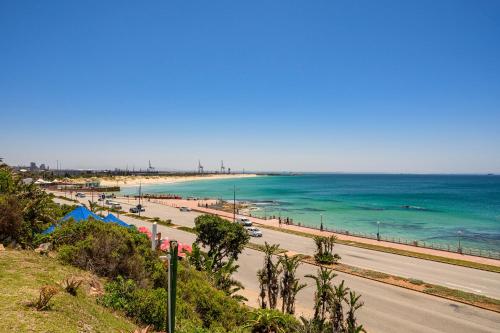 a view of a beach with the ocean and a road at Brookes Hill Suites Luxury Apartment 124 in Port Elizabeth