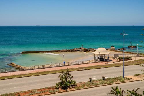 a beach with a gazebo next to the ocean at Brookes Hill Suites Luxury Apartment 124 in Port Elizabeth