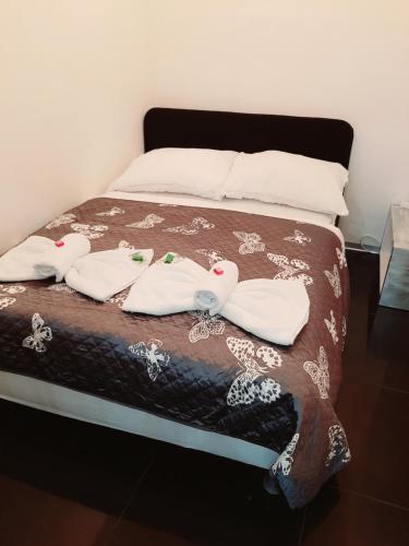 a bed with two towels on top of it at Villa Košice 2 in Košice