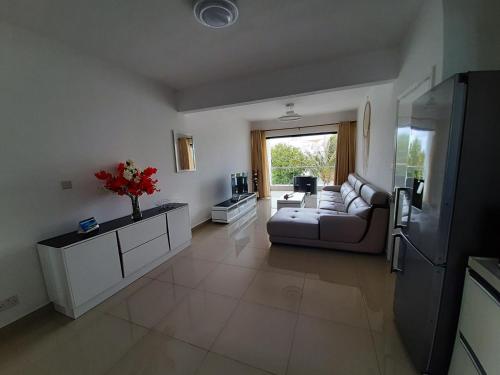 a large living room with a couch and a table at Ti Coco in Pereybere