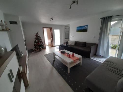 a living room with a christmas tree and a couch at The Furnas Azores House in Furnas