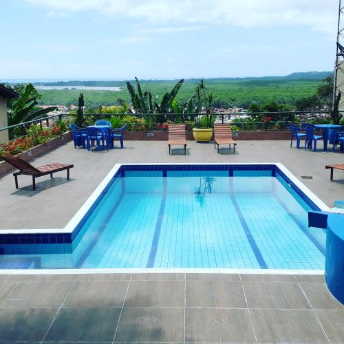 a swimming pool on the roof of a building at Alto do Aeroporto Hotel in Porto Seguro